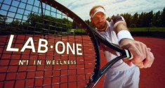 Racket in tennis players hand on tennis court